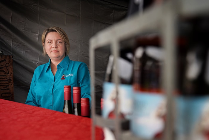 Huon Valley businesswoman Eve Knight stands in a stall at the Taste of the Huon