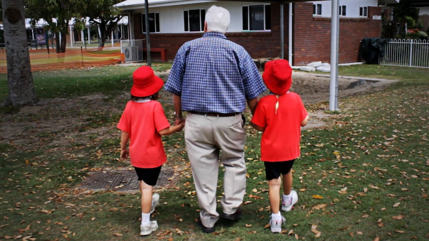 Poppy Wallace walking with two students.
