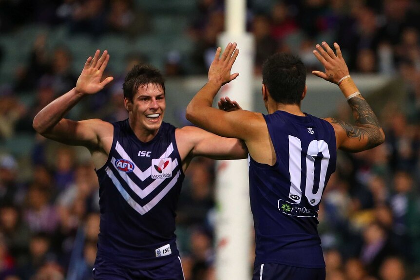 Crucial win ... Nick Suban (L) and Michael Walters celebrate a goal during the Dockers' win