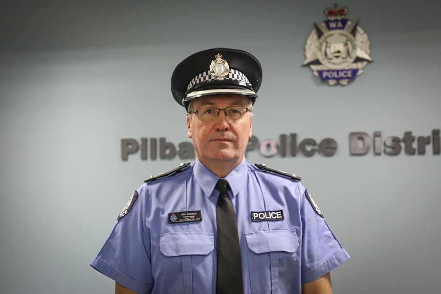 A police officer wearing his uniform and cap.