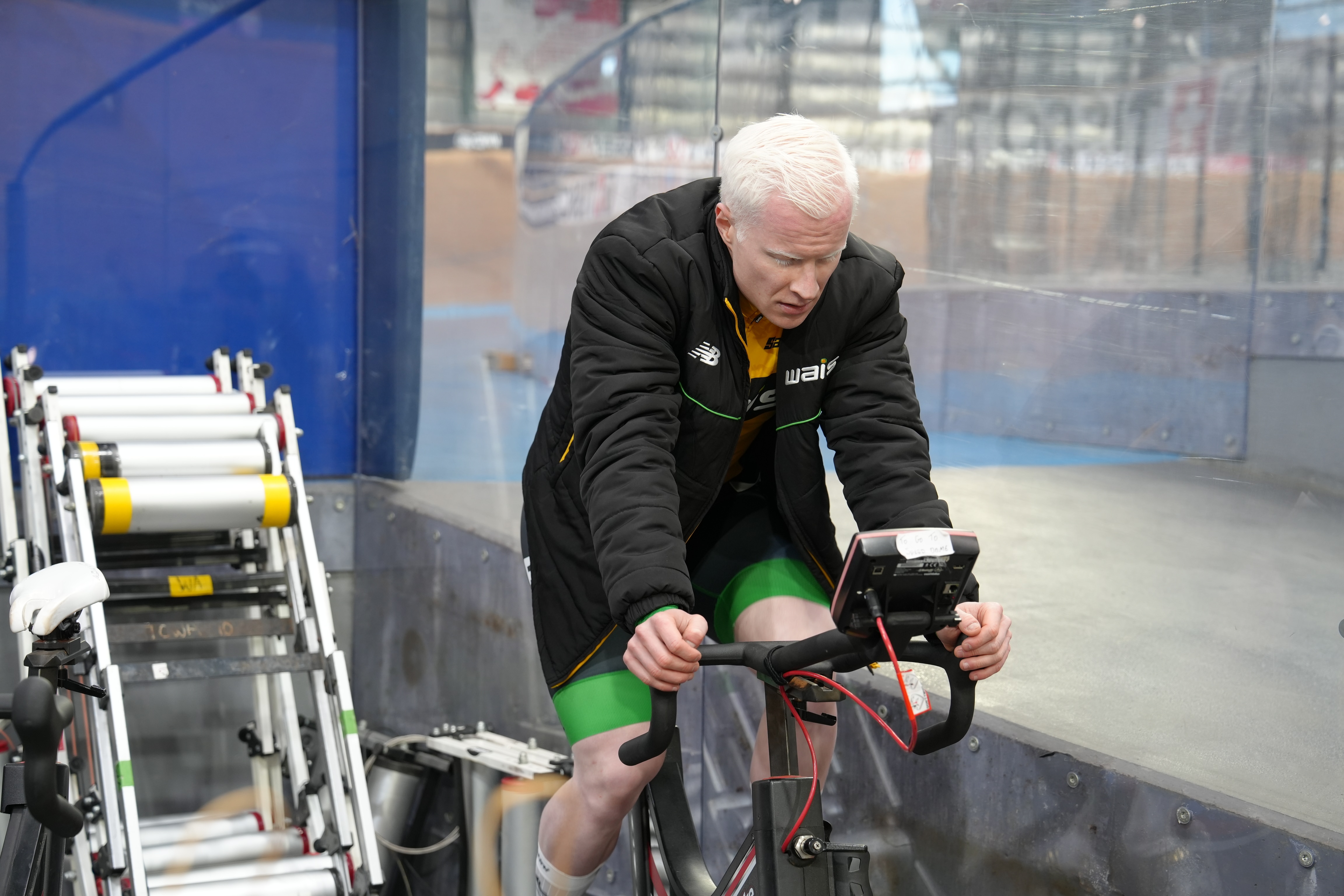 Kane Perris rides a stationary bike during a training session.