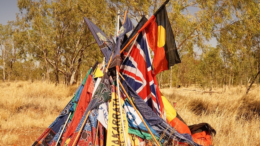 A cluster of Aboriginal flags forms a pyramid