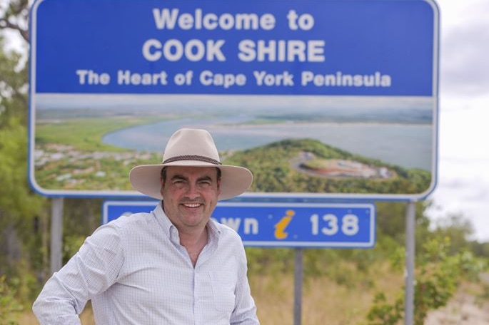 The Member for Whitsunday, Jason Costigan, stands in front of the 'Welcome to Cook Shire' road sign on Cape York.