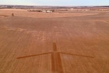 Image of a wind turbine ploughed as a protest
