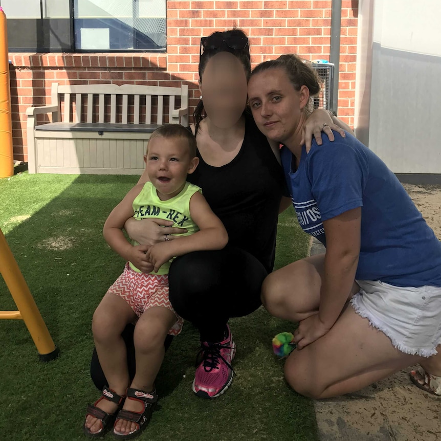 Cassandra Brown-Crane with her son Alijah and another woman at a playground.