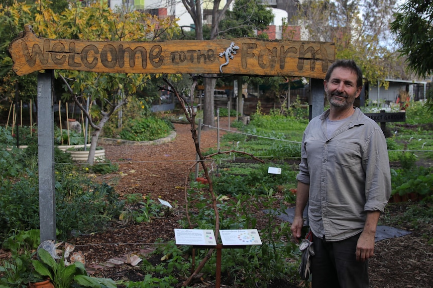 Man stands in front of signage