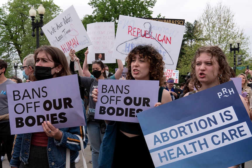 Demonstrators protest outside of the US Supreme Court