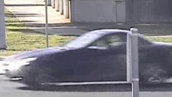 A black Mercedes coupe police believe may be linked to the death of Melbourne woman Karen Ristevski drives down the street.