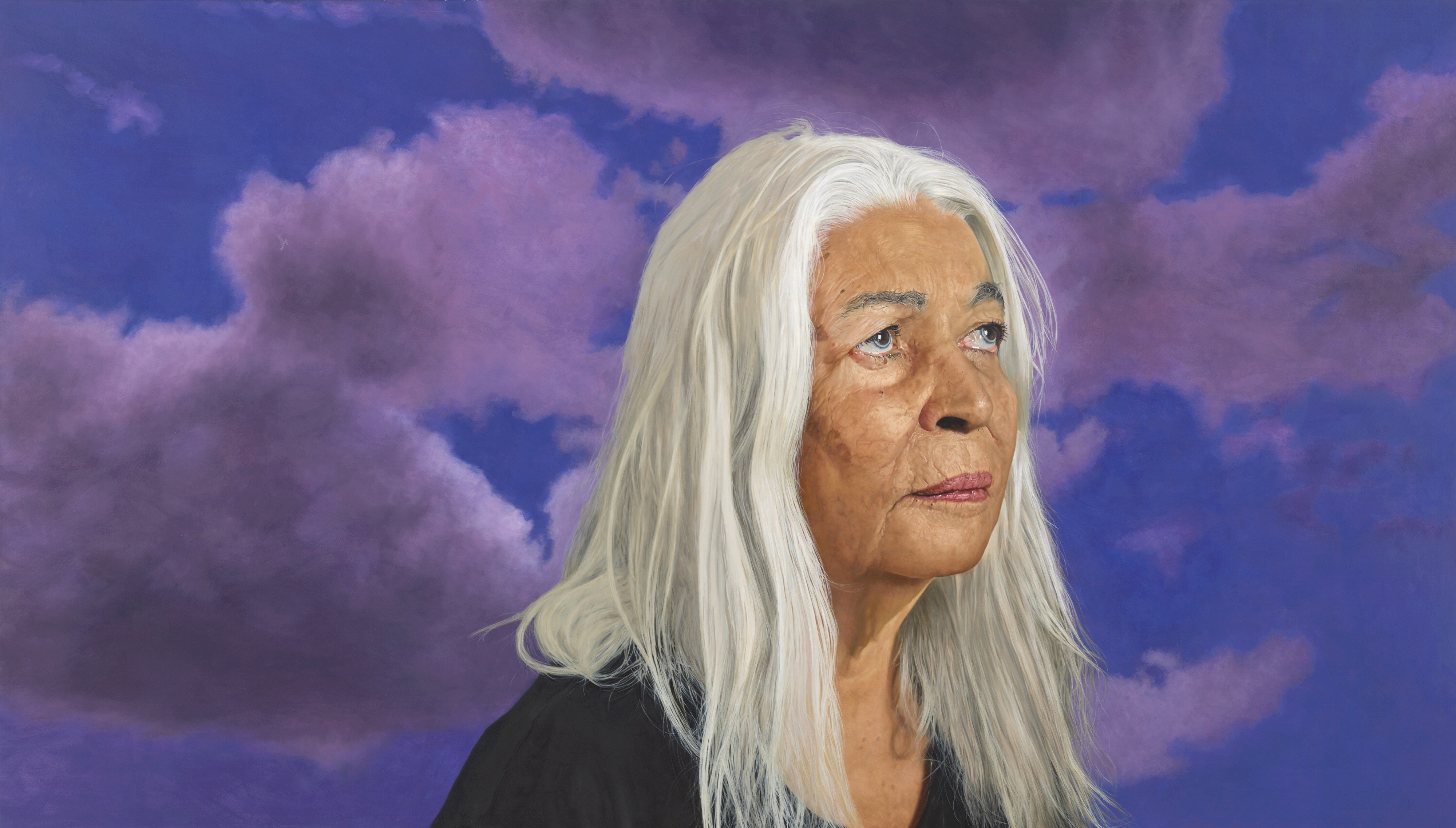 A portrait of Marcia Langton, an elderly Indigenous woman with long white hair, painted against a vivid indigo sky.