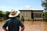 A man stands in floodwaters on a street in Dalby in the Lockyer Valley in southern Queensland.