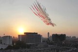 Egyptian military jets fly over protest in Tahrir Square.