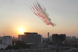 Egyptian military jets fly over protest in Tahrir Square.