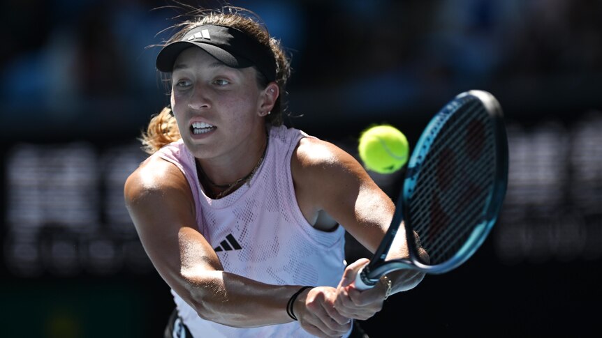 An American female tennis player stretches for a backhand return at the Australian Open.