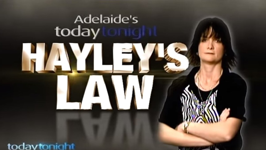 A woman standing in front of the words Hayley's Law