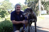 A man with his pet greyhound