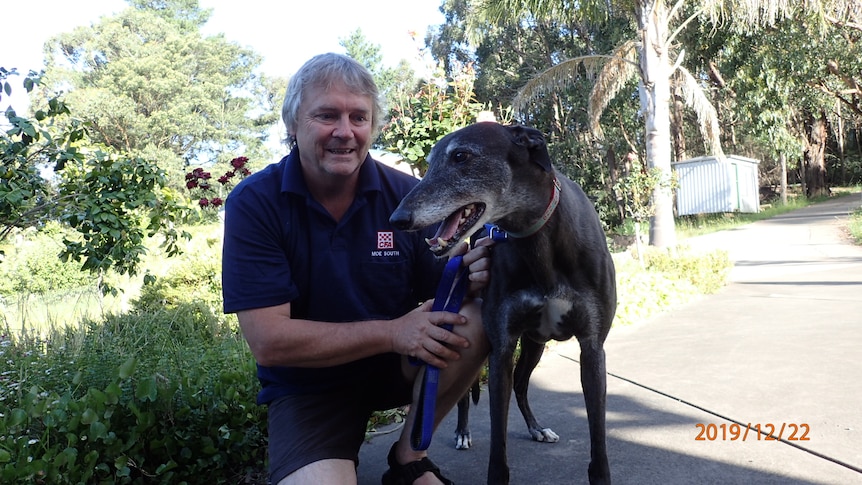A man with his pet greyhound