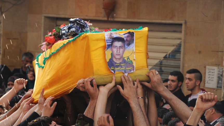 Mourners carry coffin of killed Hezbollah member