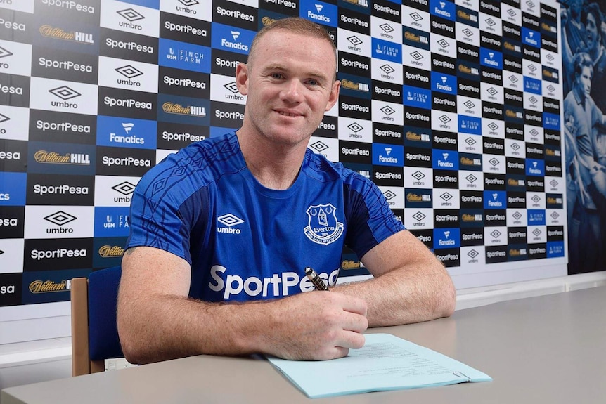 Wayne Rooney, in an Everton kit, signs a two-year contract.