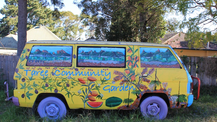 Old van placed in Taree Community Garden painted in bright colours at entrance.