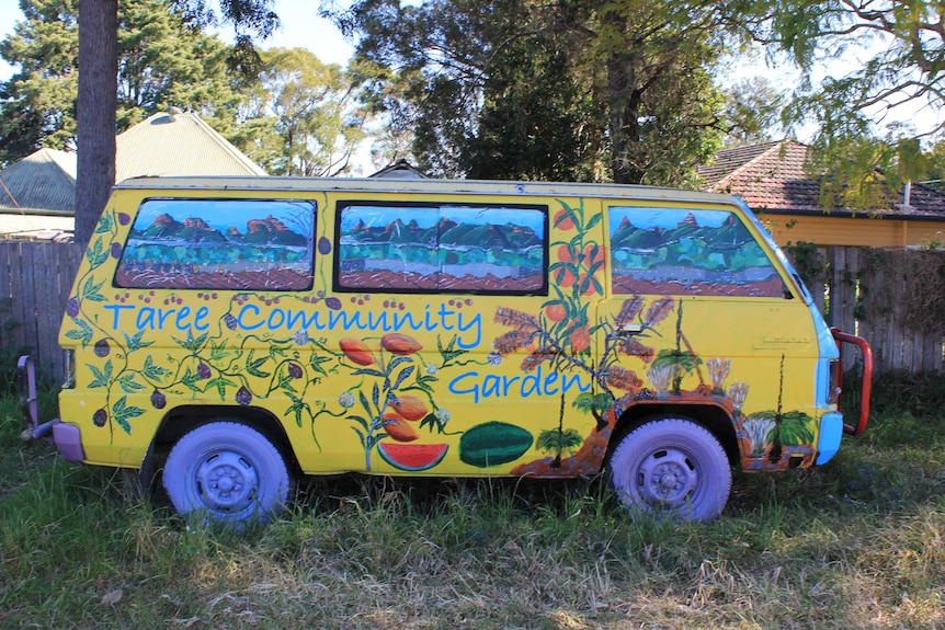 Old van placed in Taree Community Garden painted in bright colours at entrance.