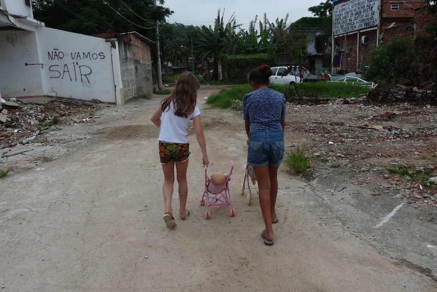 Children in the streets of the partly-demolished slum area neighbouring Rio's Olympic Park