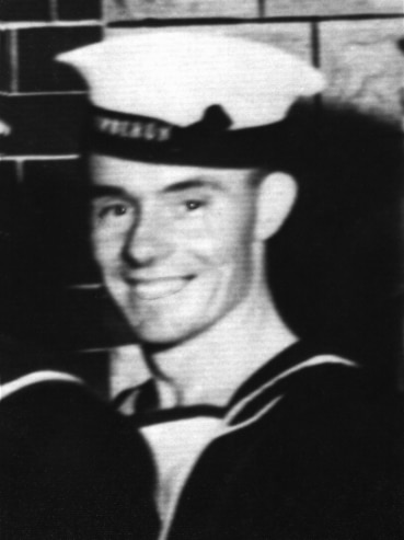 A black-and-white photo of a young man in a Navy uniform.