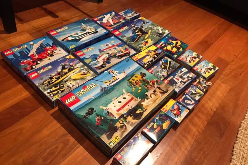 A collection of vintage Lego sets, still in their boxes.