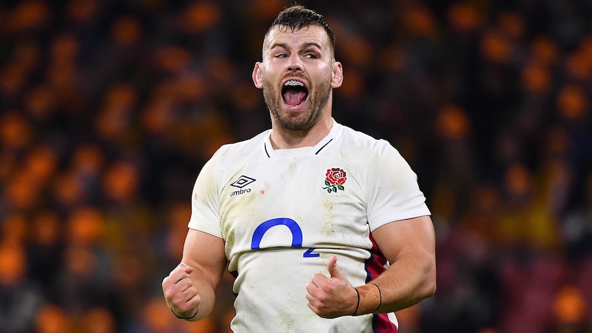A male England rugby union player pumps his fists during Test against Australia.
