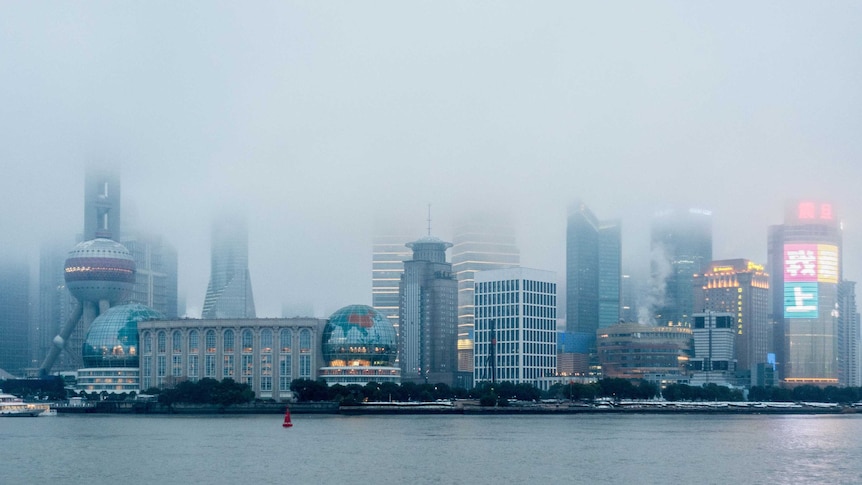 A city skyline in fog.