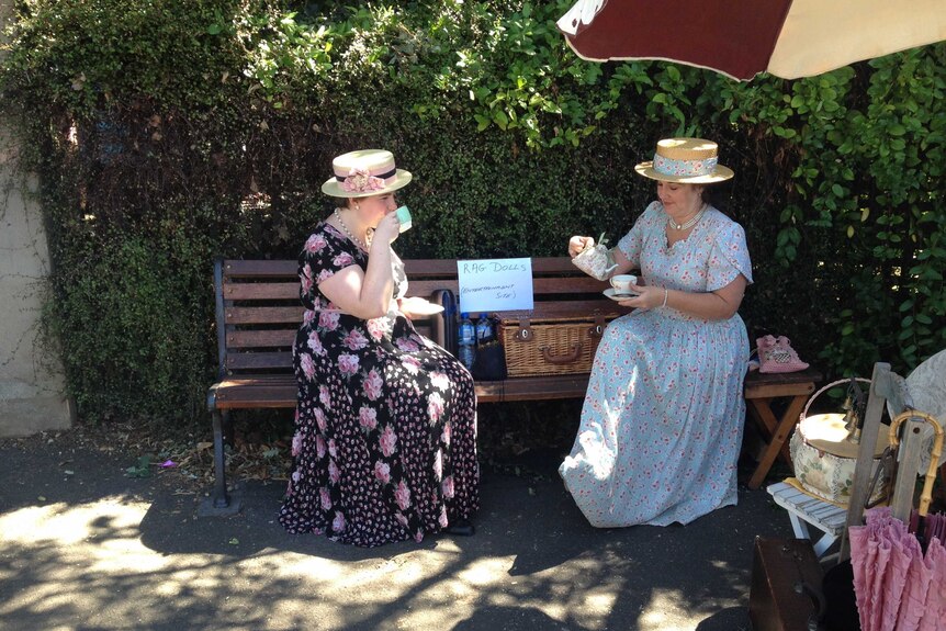 Ladies break for tea as they watch the penny farthings