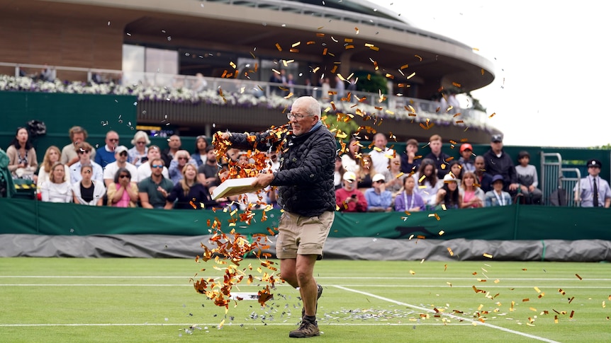 A protester throws confetti on the Wimbledon court