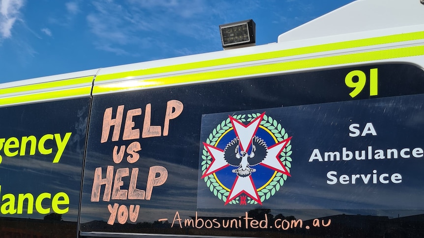 Writing on the side of an ambulance says 'help us help you'