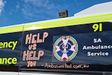 Writing on the side of an ambulance says 'help us help you'