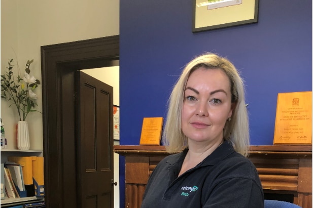 Colony 47's housing solutions manager Bella Fountain sits at a desk.