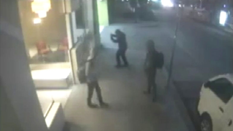 Three members of a neo-Nazi group outside the ALP's Victorian headquarters where they put up homophobic posters.