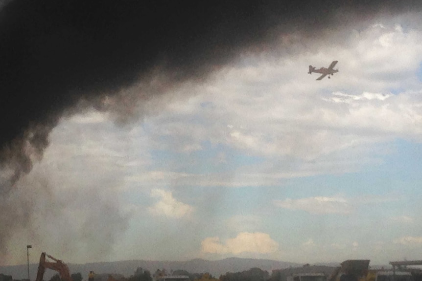 A water bomber fights a fire at Burton