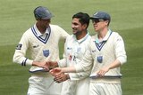 Jason Sangha (centre) is congratulated by New South Wales teammates after taking a Sheffield Shield wicket.