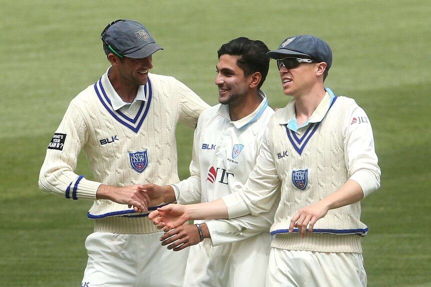 Jason Sangha is congratulated on a Shield wicket for NSW