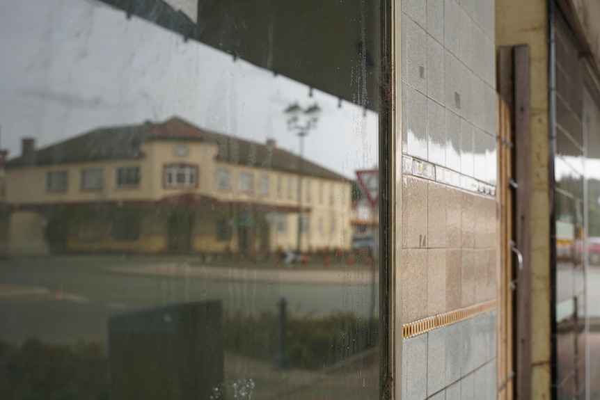 A closed down hotel shown in a window reflection