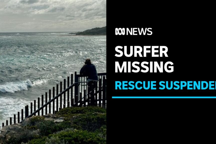Surfer Missing, Rescue Suspended: A man at a fenced lookout gazes out at a choppy ocean.