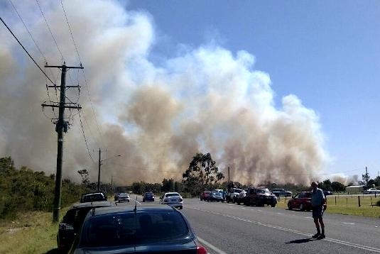 Cars are being stopped along Lemon Tree Passage Road because of smoke from a bushfire at Salt Ash.