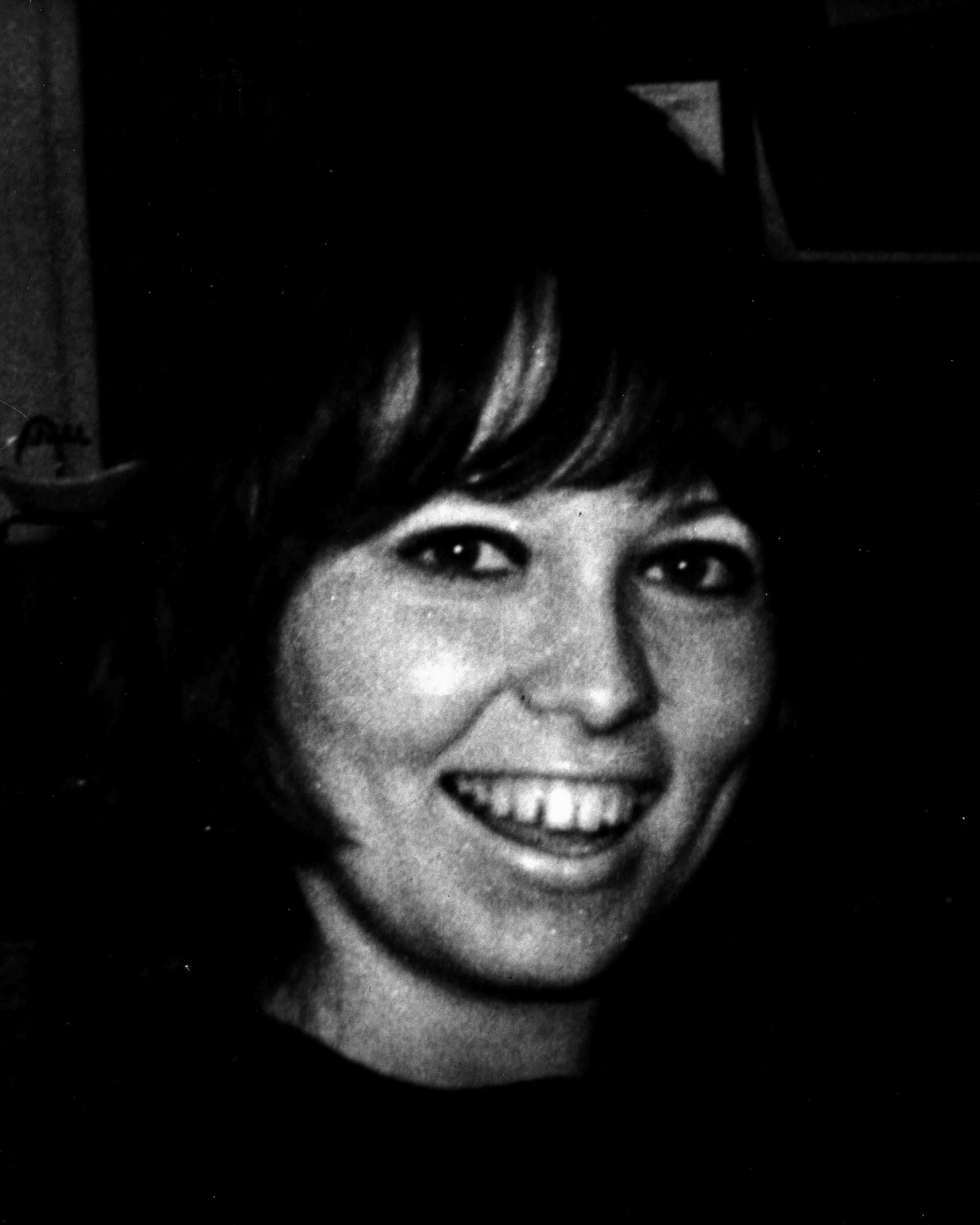 An old, grainy photo of a young woman.