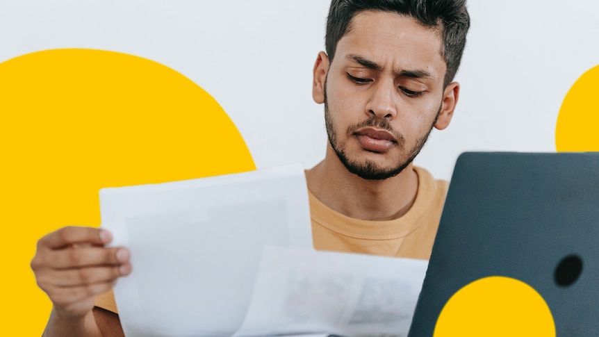 Man checking his super balance on paperwork and looking thoughtful, in a story about how much superannuation should you have.