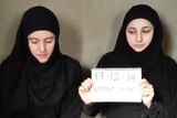 Italian aid workers wearing black dresses and headscarves in still of video posted to unofficial Islamic channel