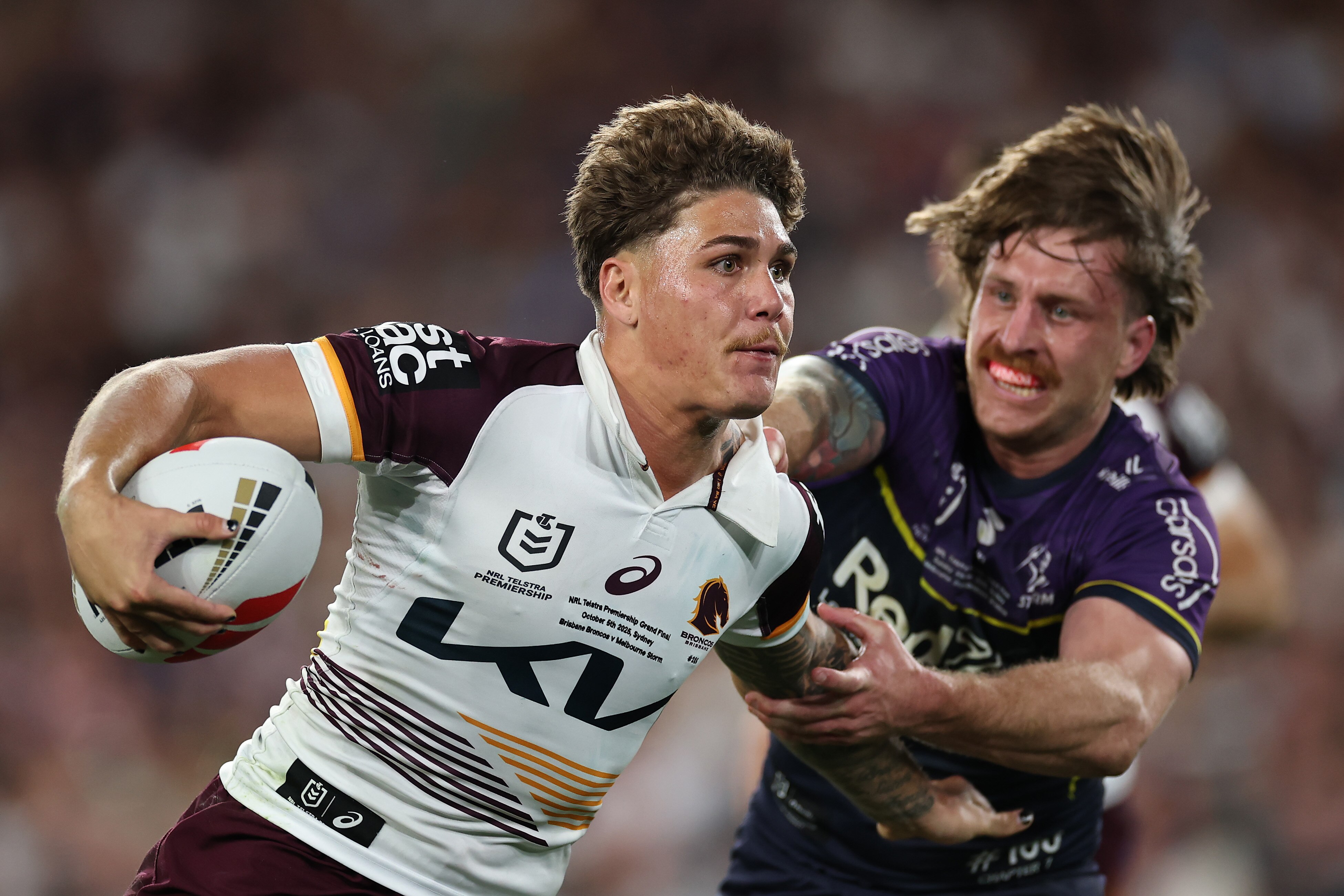 Reece Walsh fends off Cameron Munster in the NRL grand final.