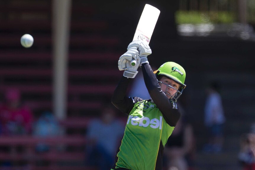 Rachael Haynes watches the ball after playing to the leg side against the Renegades in their WBBL match at North Sydney Oval.