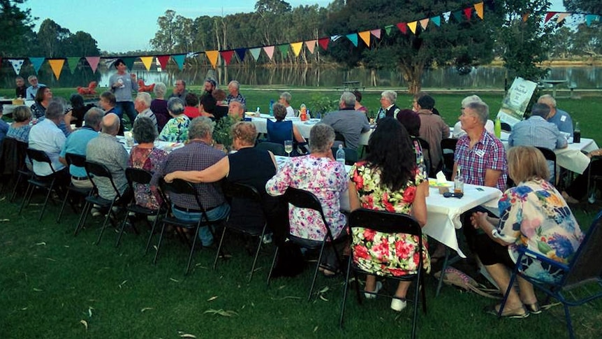 people sitting a table having dinner