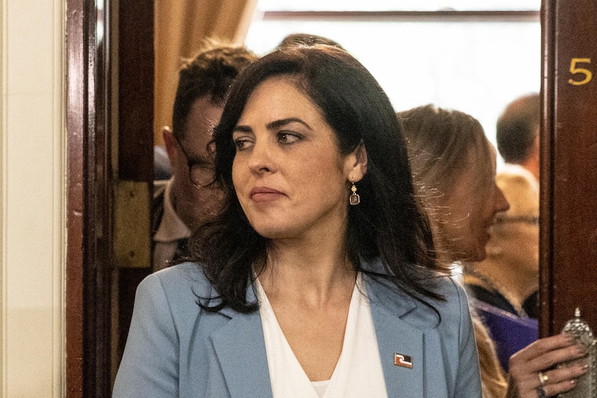 A woman leaving a meeting room in parliament