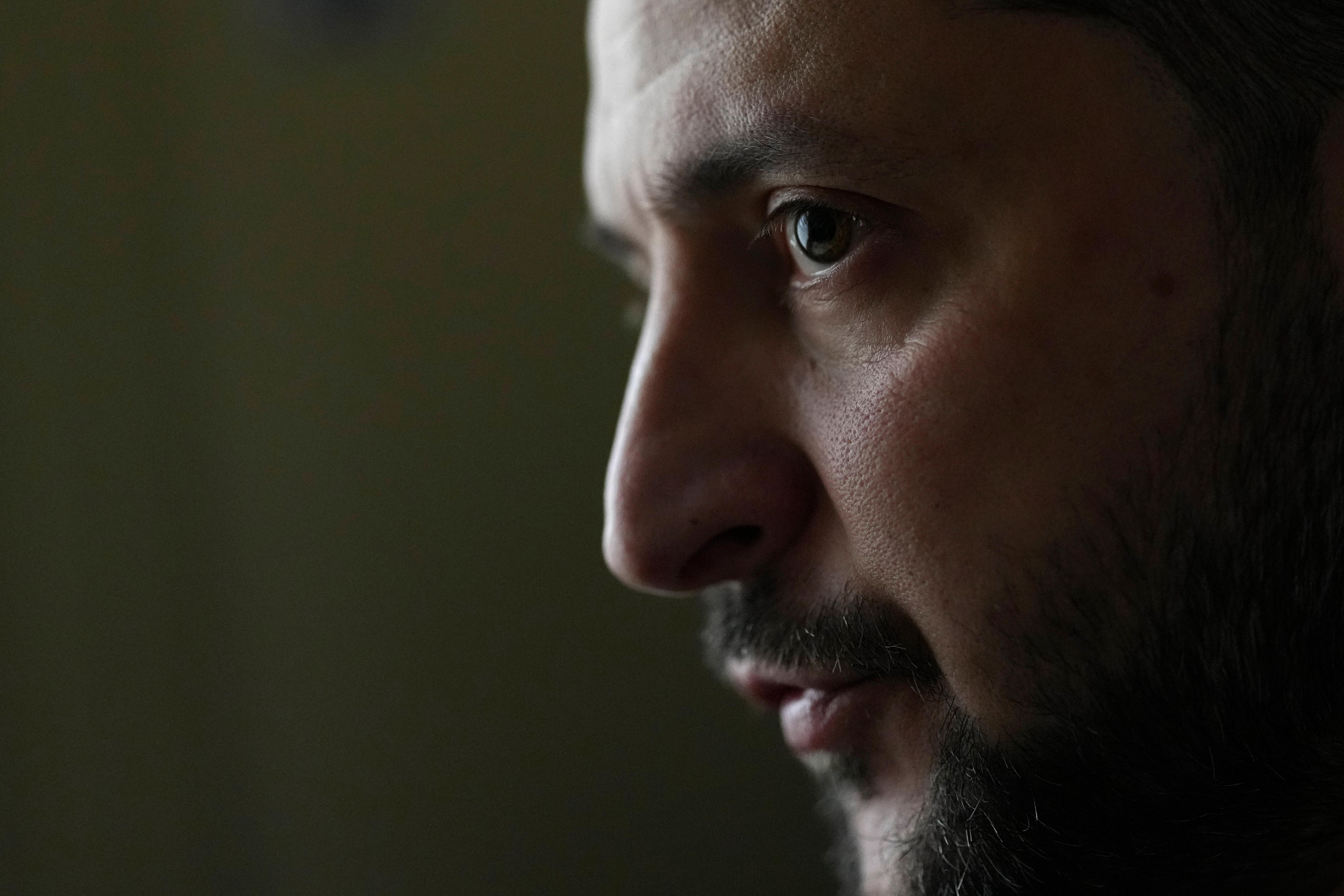A close-up shot of a man with a neatly trimmed beard.