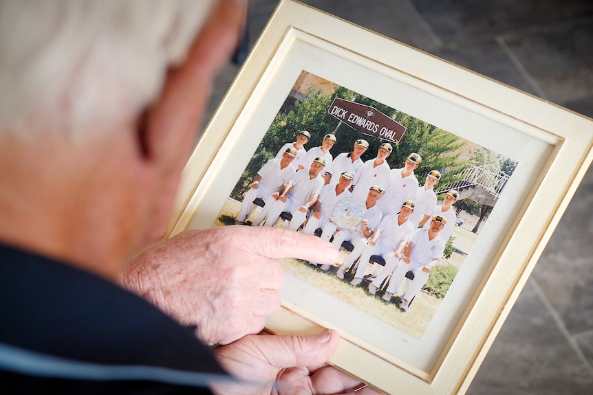 Doug Crowell looks at the photo frame